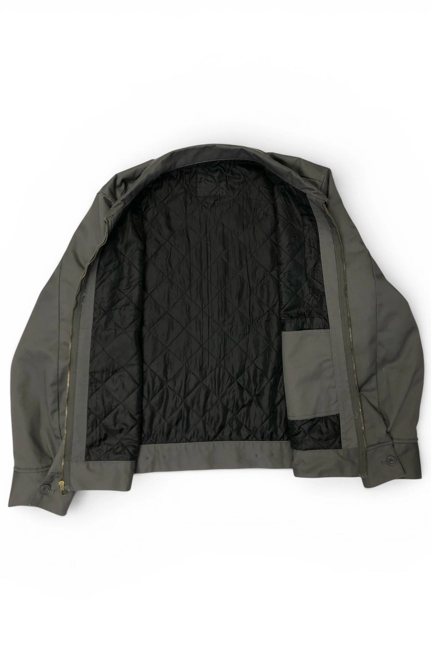 Interior view of the Common Saints dark gray mechanic jacket with black diamond-quilted lining and inner patch pocket