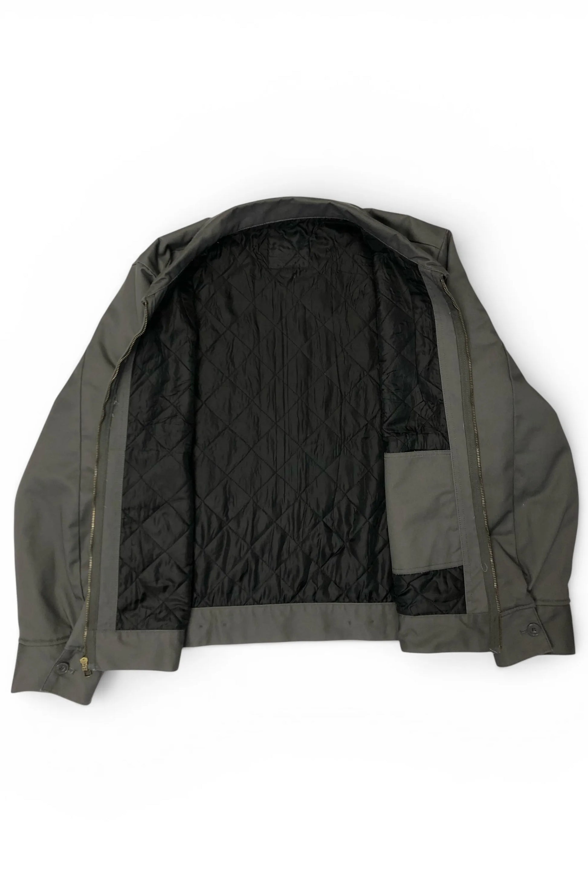 Interior view of the Common Saints dark gray mechanic jacket with black diamond-quilted lining and inner patch pocket