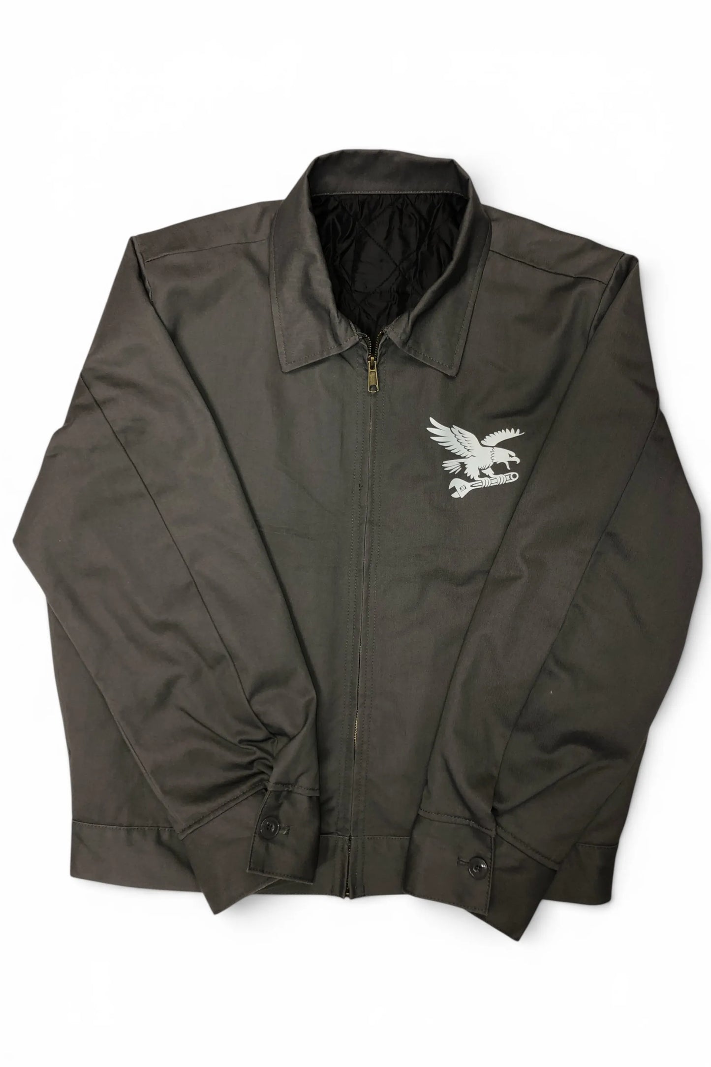 Front view of Common Saints dark gray zip-up mechanic jacket with white eagle-and-wrench chest graphic and pointed collar