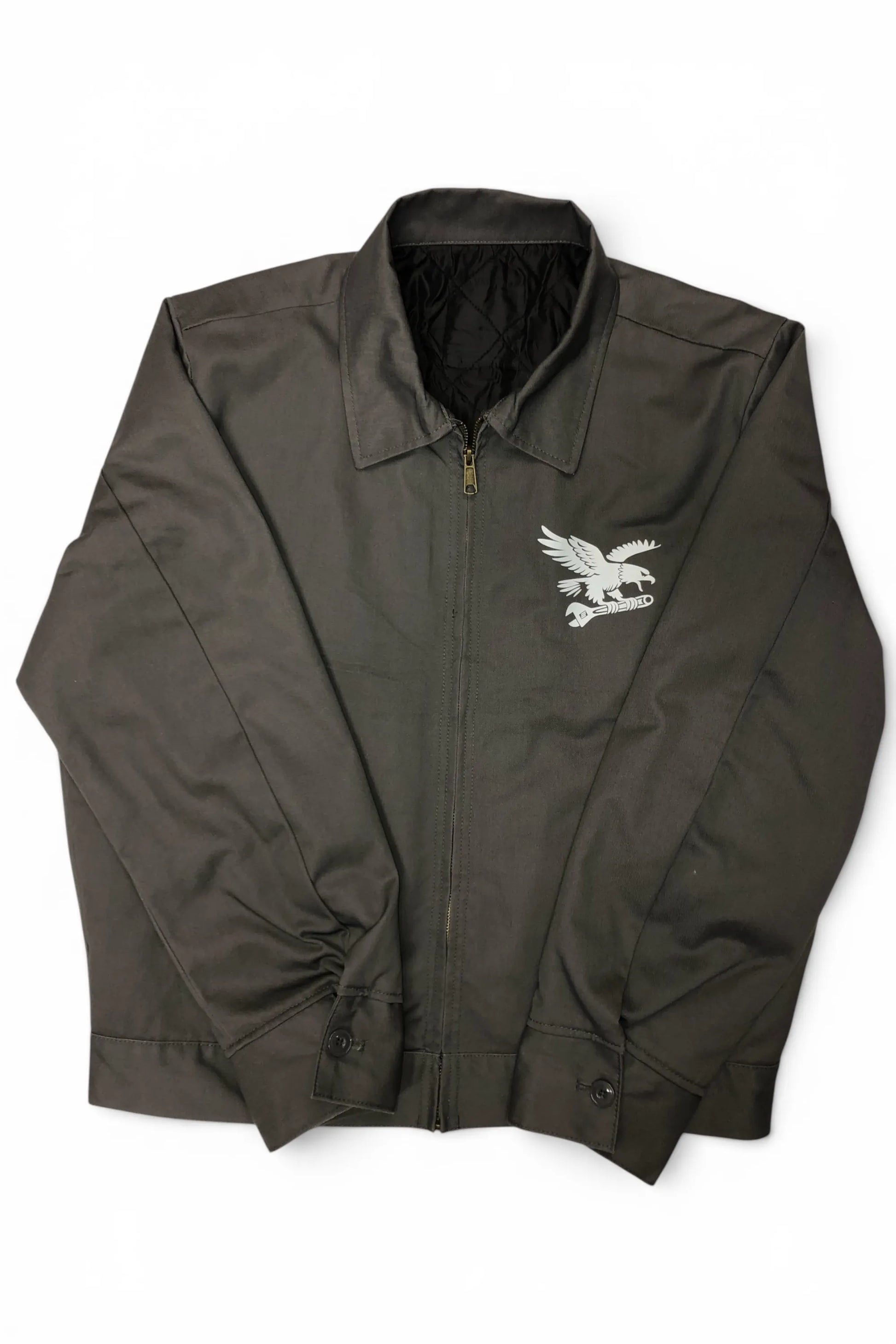 Front view of Common Saints dark gray zip-up mechanic jacket with white eagle-and-wrench chest graphic and pointed collar