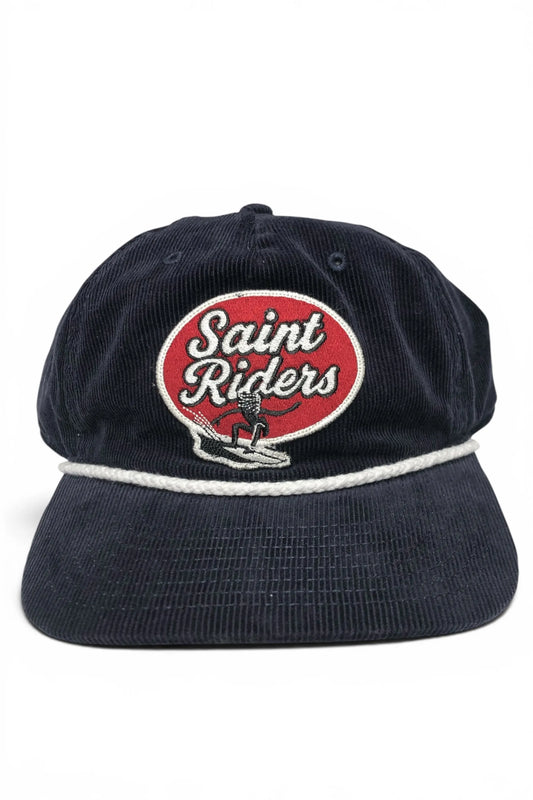 Common Saints Coast Ink Blue five-panel corduroy snapback cap with Saint Riders patch and white rope detail, front view